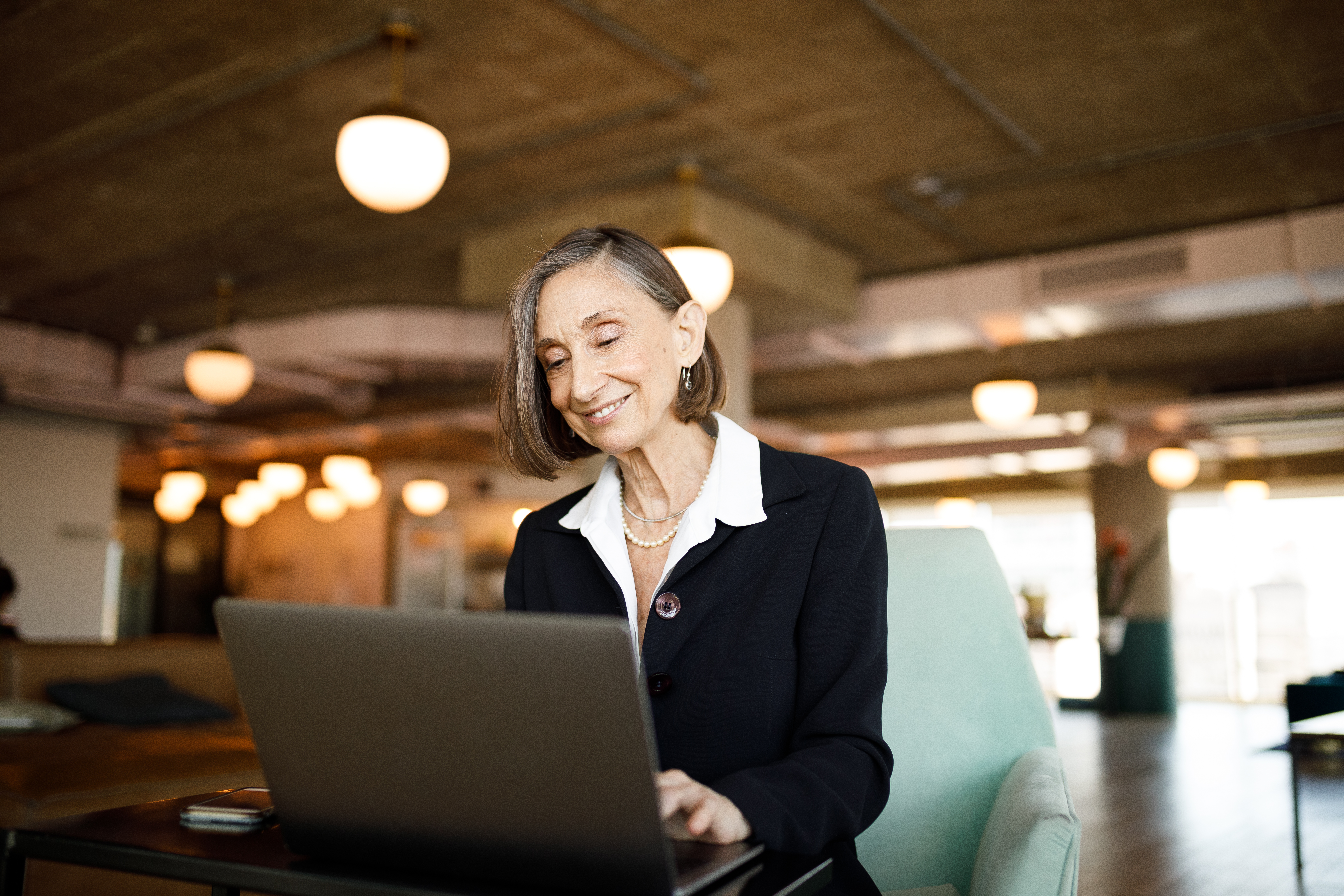 Senior businesswoman using laptop at coworking