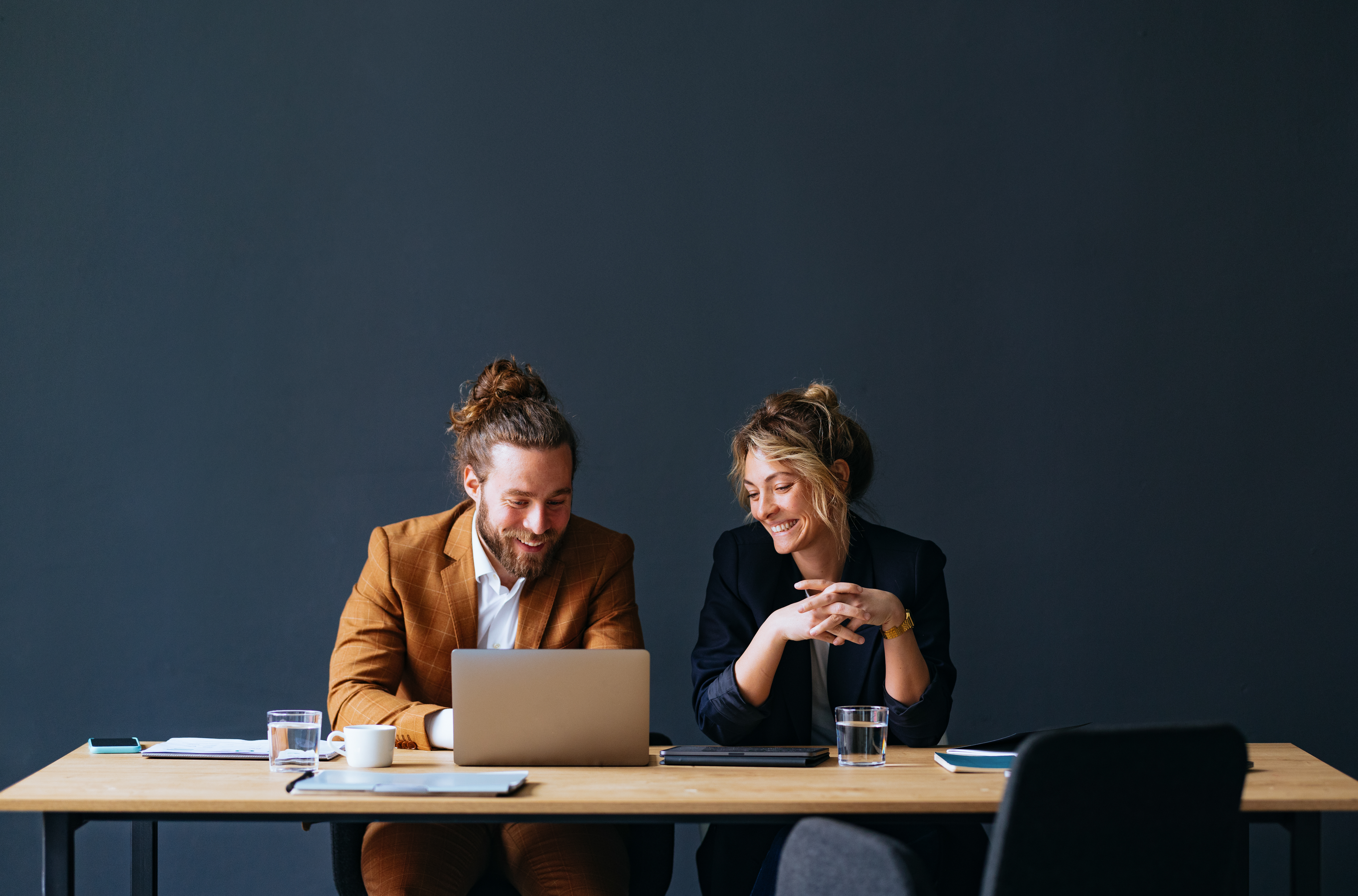 Two Happy Colleagues Working Together On A New Project