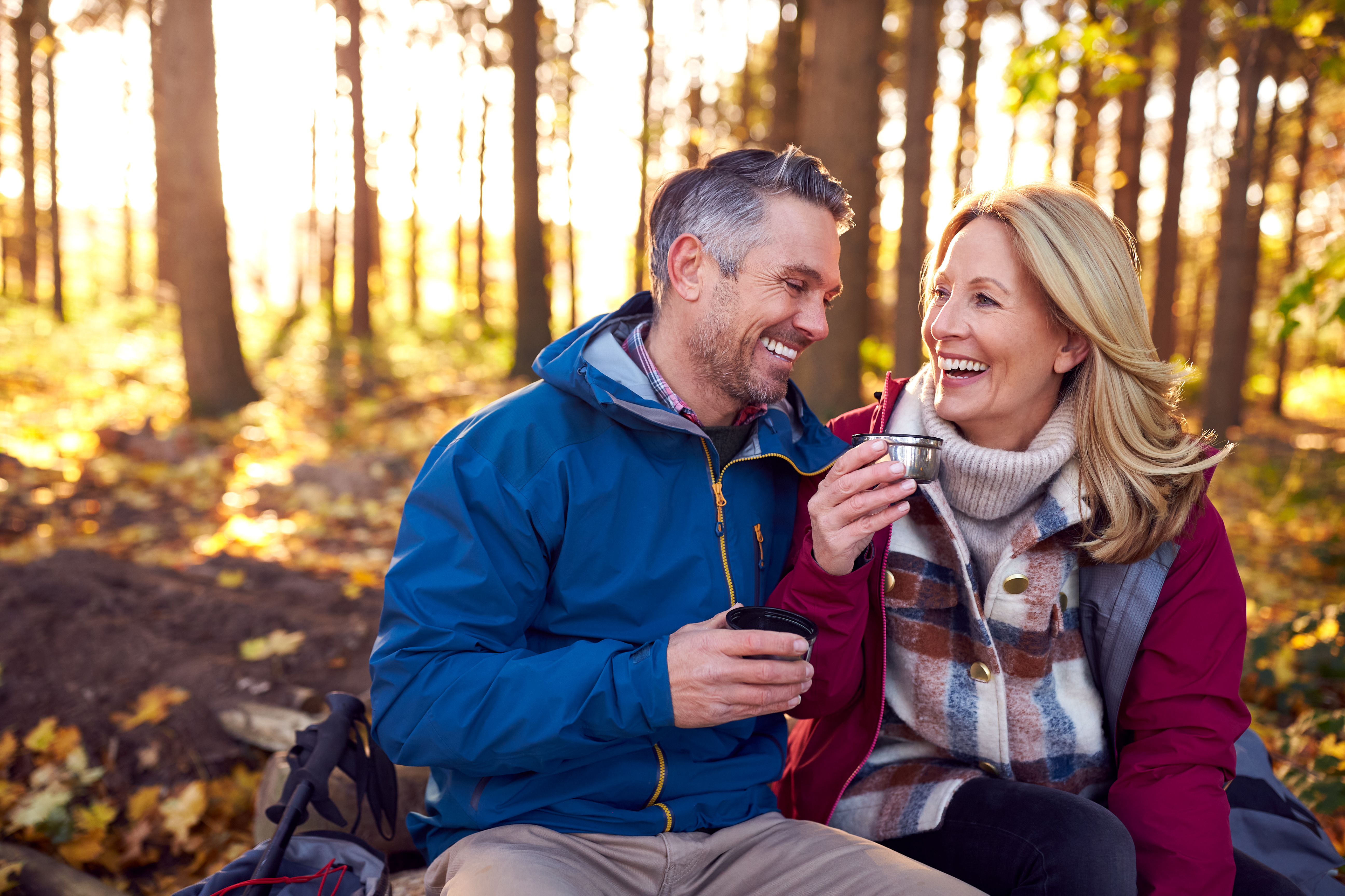 Mature Retired Couple Stop For Rest And Hot Drink On Walk Through Fall Or Winter Countryside