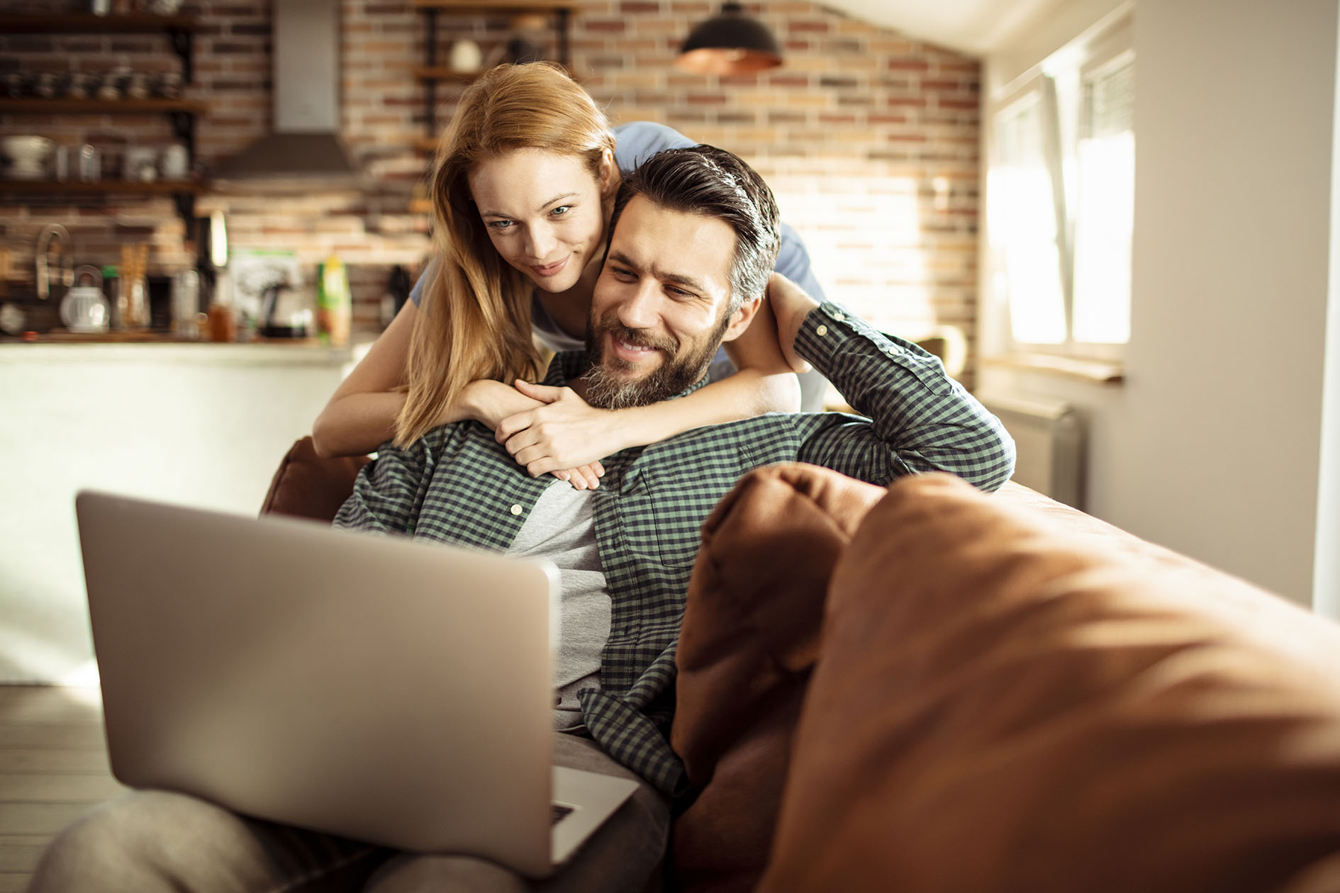 Young Couple using a Laptop at home